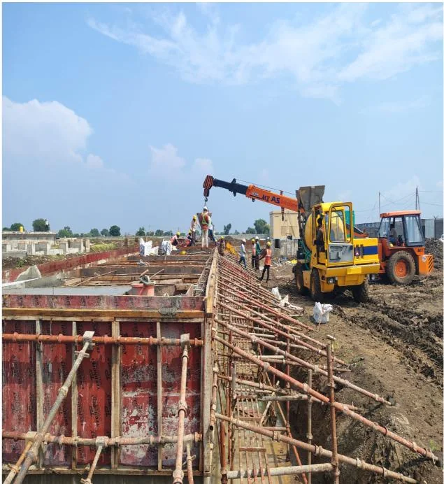 Excavator working alongside formwork on a foundation