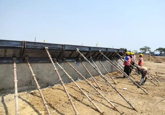 Reinforcement and shuttering for a retaining wall