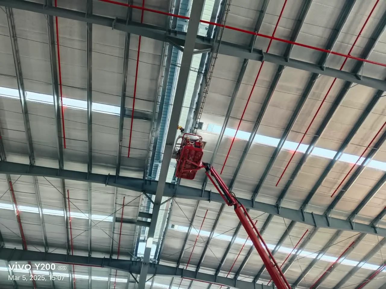 Fire sprinkler piping along a warehouse ceiling