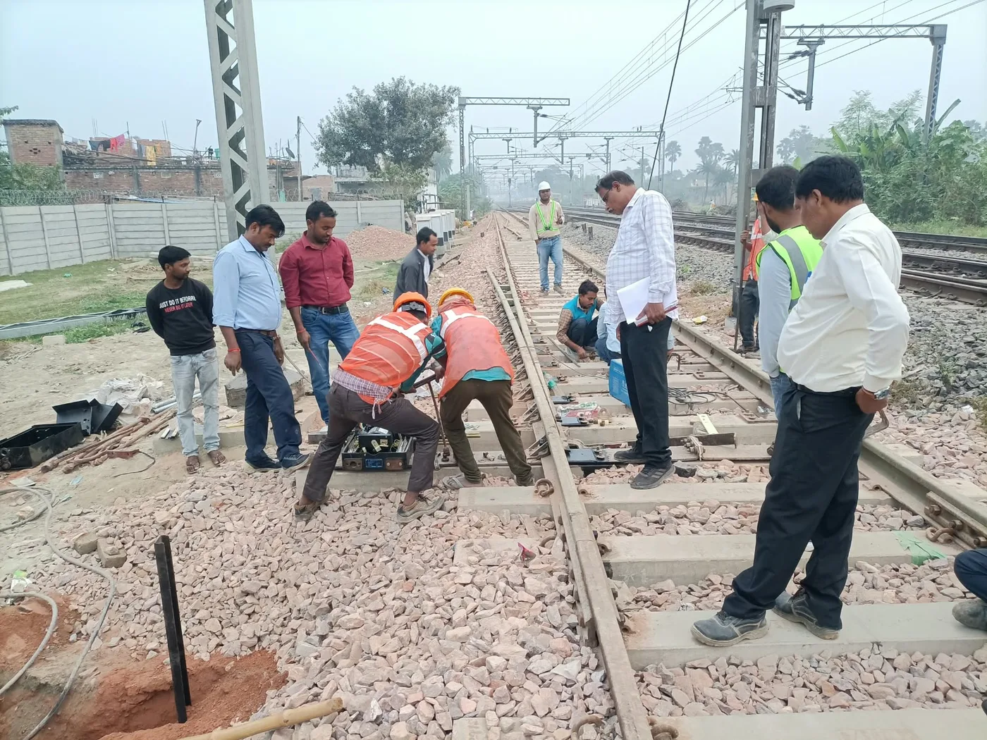 Track fitting work under inspection by site engineers